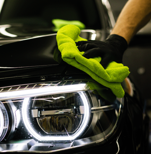 closeup-shot-of-a-man-cleaning-car-headlight-with-2022-12-19-08-41-28-utc